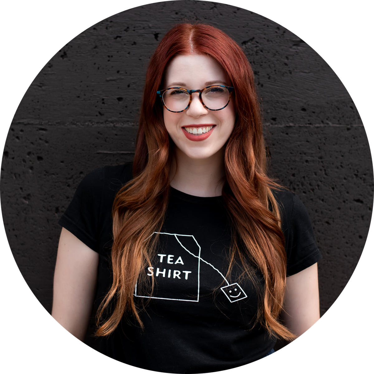Smiling woman with glasses and red hair at Stone Silo Counseling.