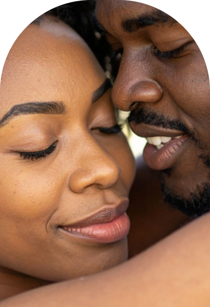 Close-up of an African American couple with faces touching and smiling, showing affection.