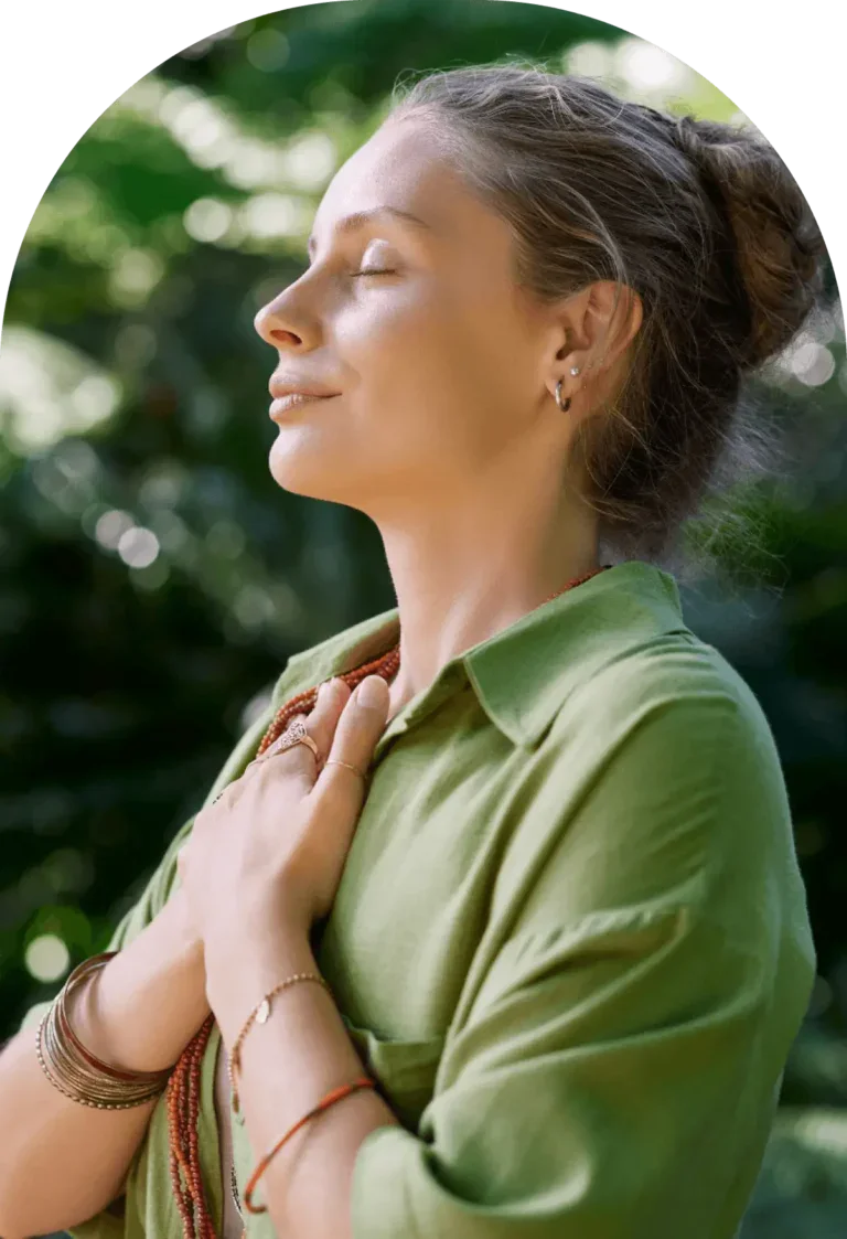 Serene woman practicing mindfulness outdoors in nature.